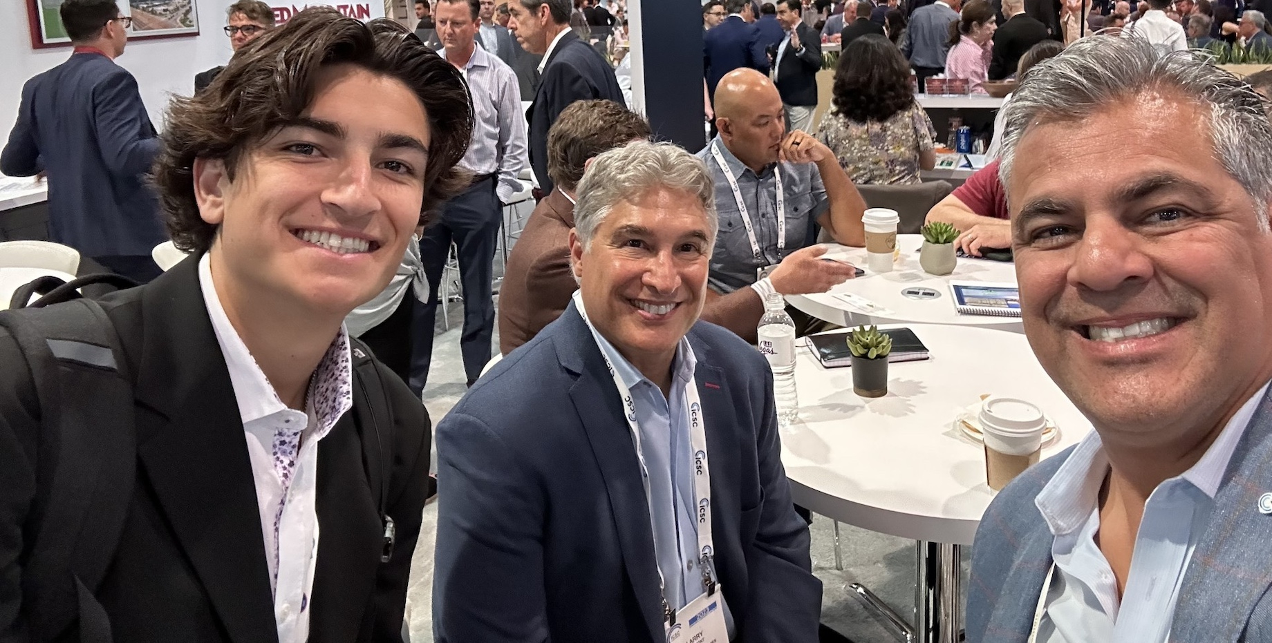 Kosmont Cos. CEO Larry Kosmont, center, president Ken Hira, right, and intern Kaden Hira at ICSC LAS VEGAS in 2023. Kaden is 