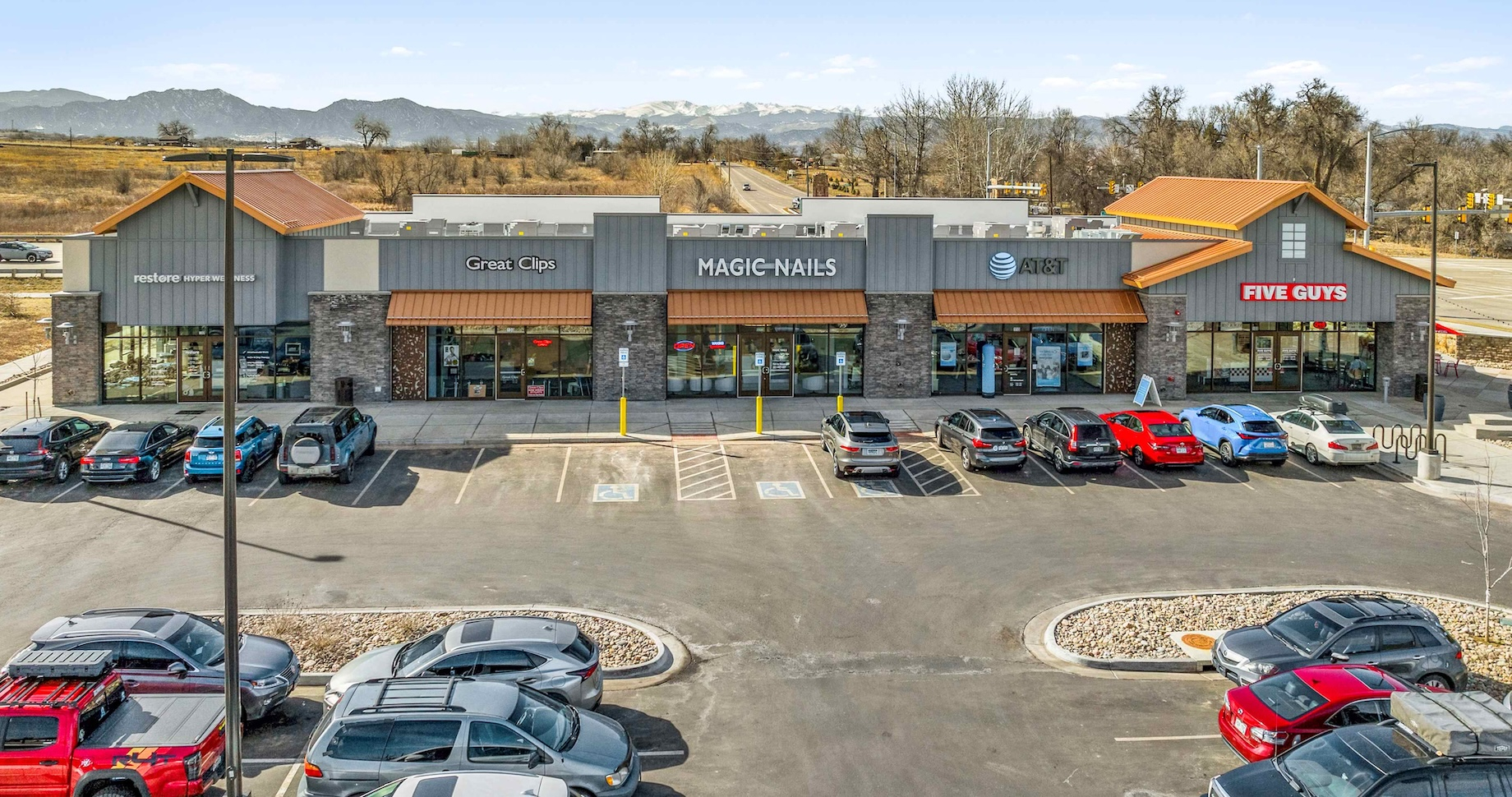 An inline building at Nine Mile Corner houses Five Guys and other service tenants.