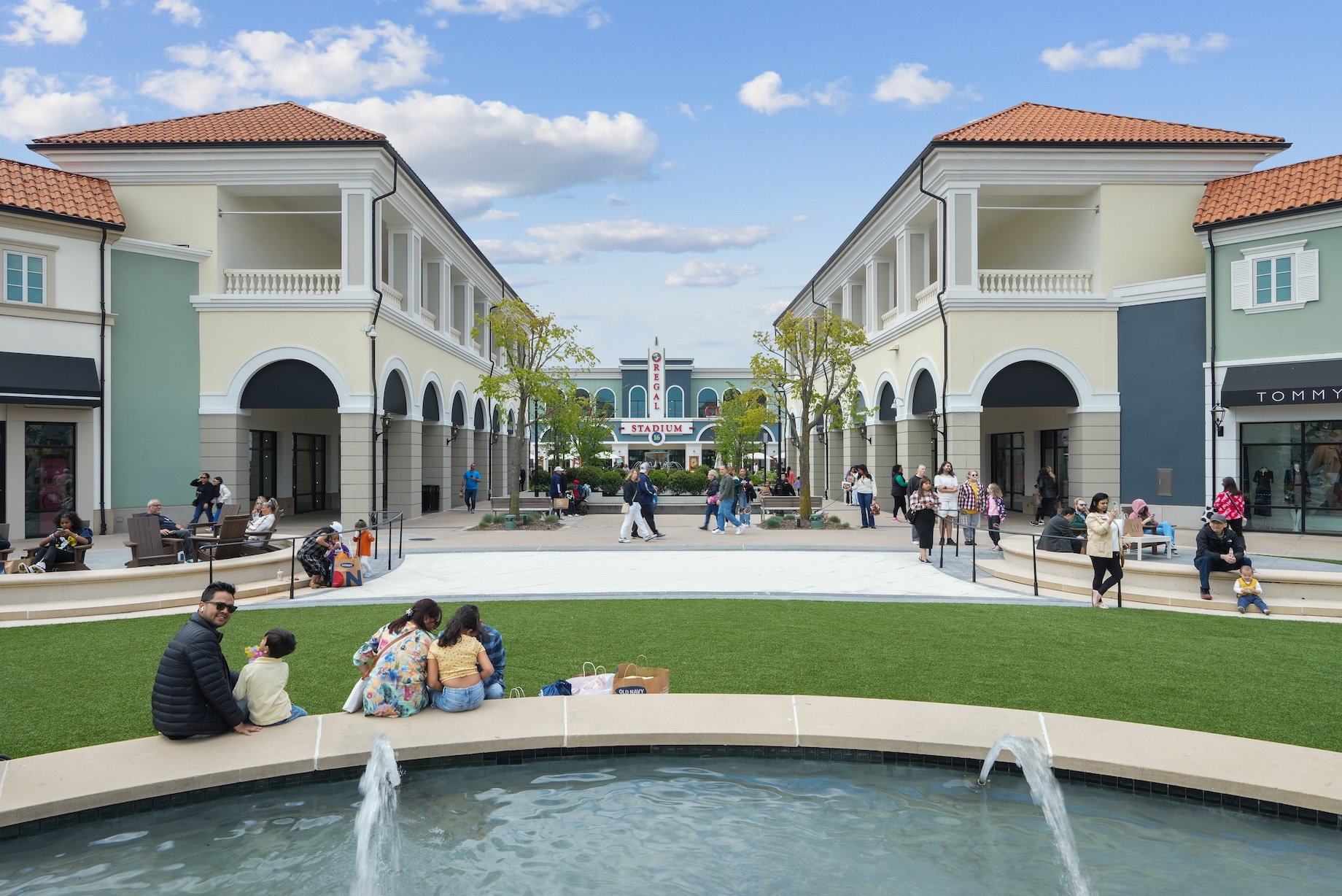 Friends and families linger and enjoy the green space at Tanger Deer Park on Long Island in New York.