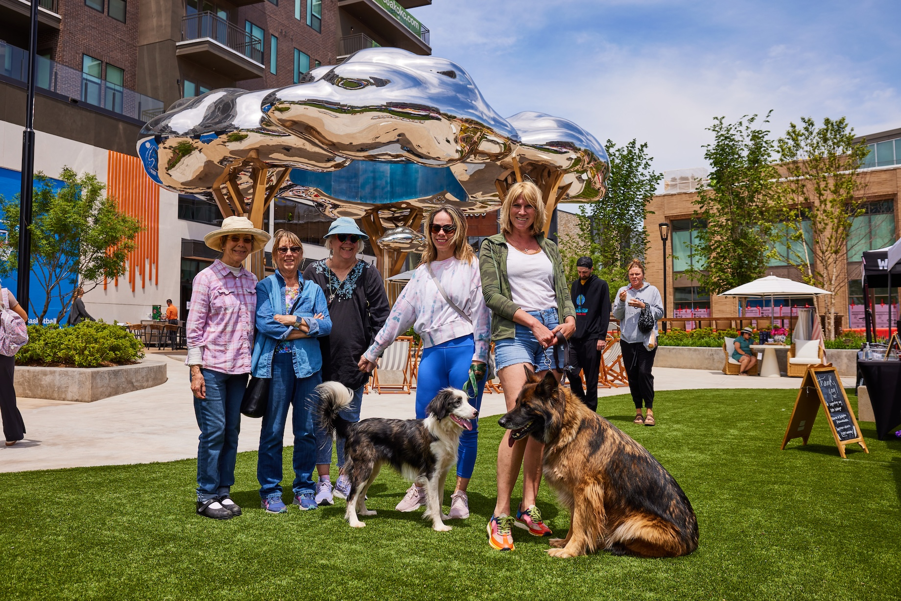 Shoppers and their dogs hang out at Oak, a new mixed-use project in Oklahoma City.