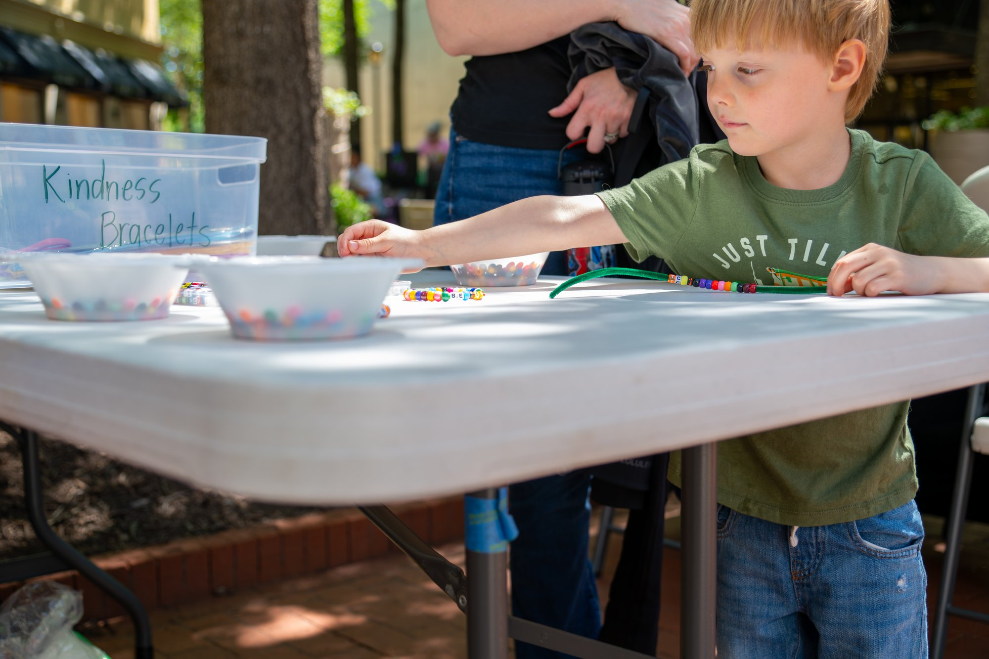At Stony Point Fashion Park in Richmond, Virginia, guests at the Spring Festival made kindness bracelets. The team also distr