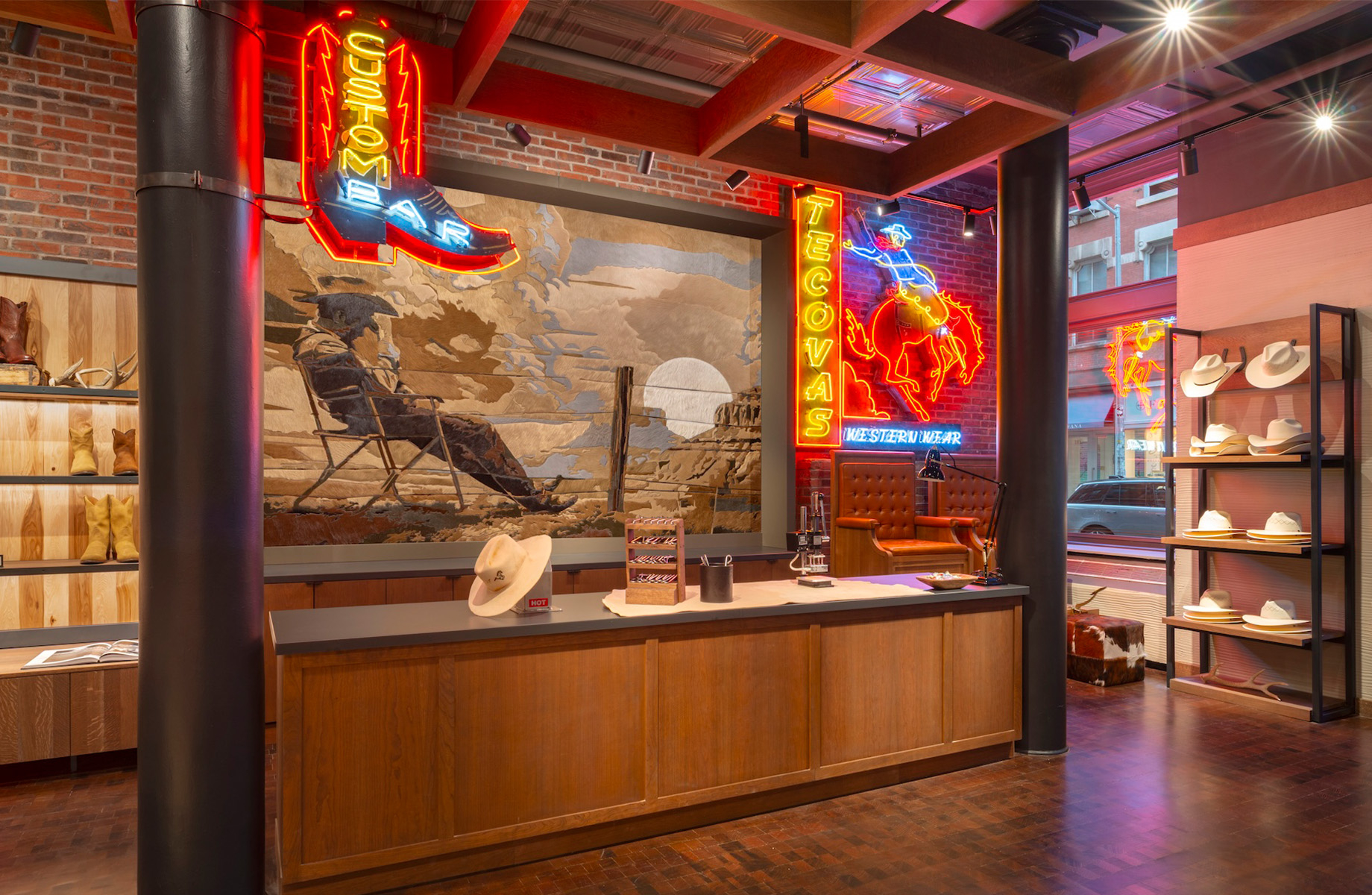 Neon signage highlights the boot- and hat-customization zone near the front of the store.