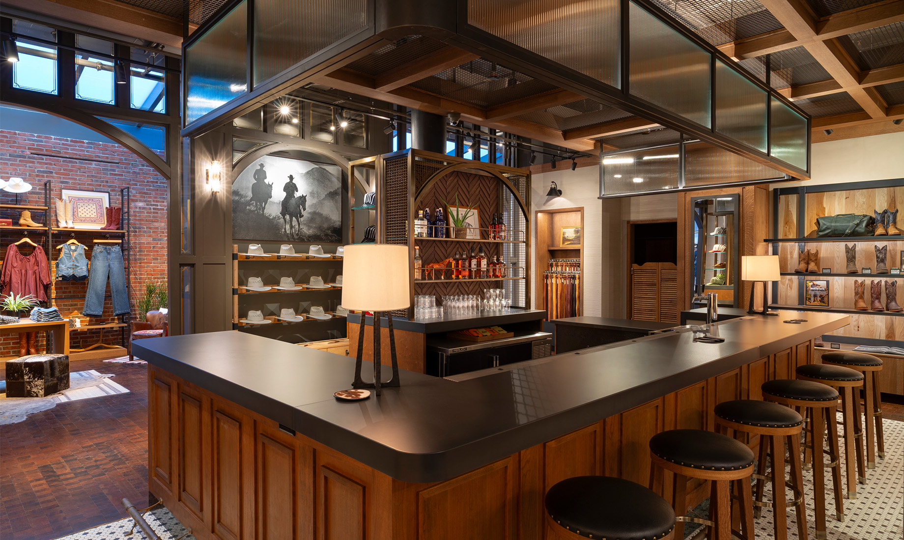 The custom-built bar reinforces the store’s destination feel, while restored skylights bring natural light into the apparel a