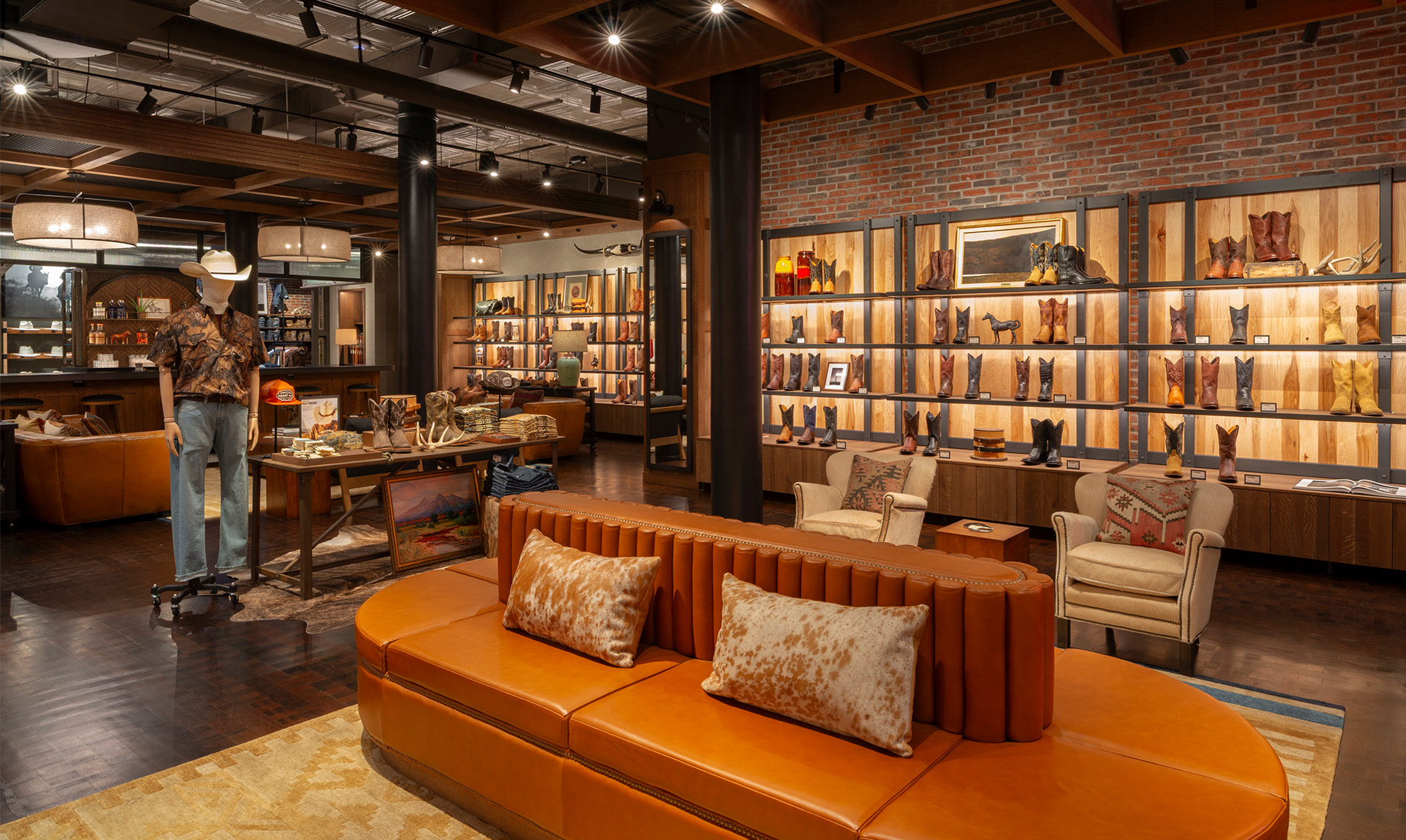 A circular leather sofa serves as a custom centerpiece, offering a gathering spot at the heart of the store.