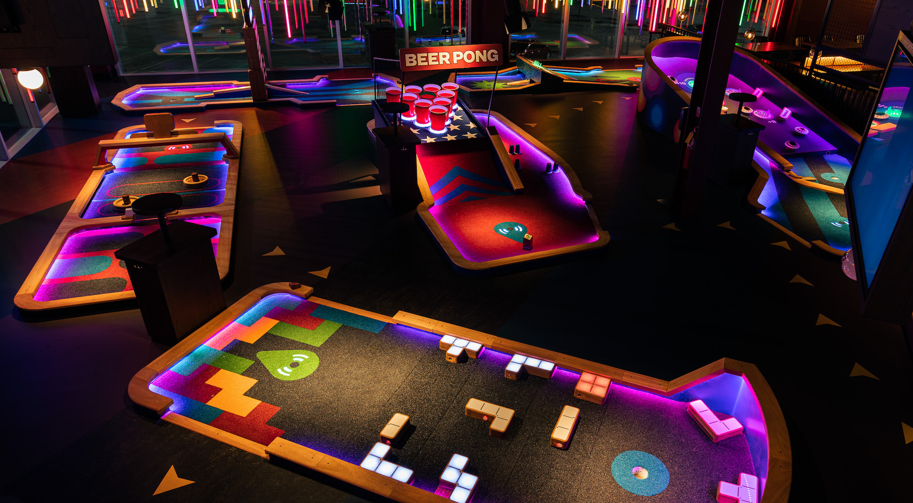 Puttshack, pictured here at Illinois’ Oakbrook Center and at top, includes not only mini-golf courses but also cocktails and 