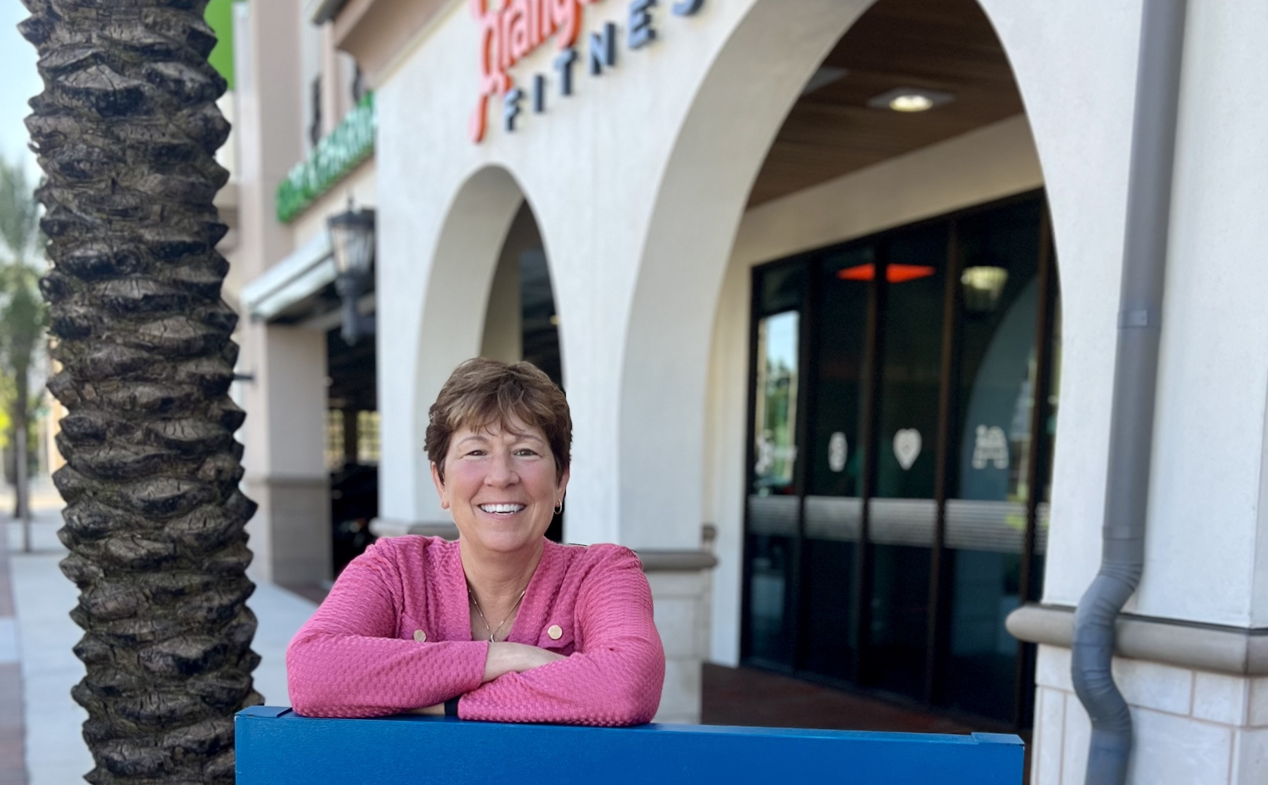 Regency Centers’ Lisa Palmer in front of Orangetheory Fitness — one of her favorite hobbies, she said — at Regency Centers’ E