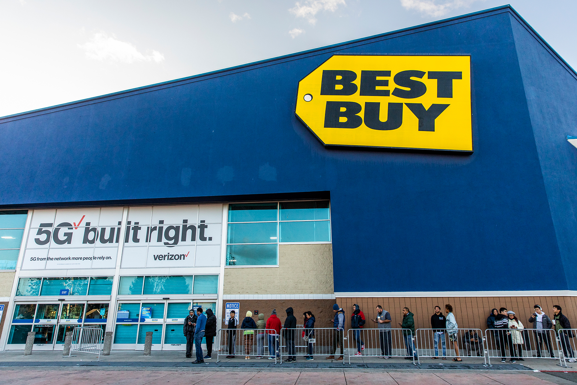Black Friday shoppers wait for the opening of a Best Buy store, in Emeryville, Calif.