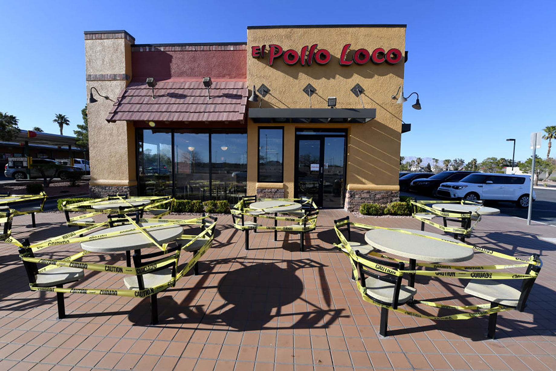 Tables and chairs in front of an El Pollo Loco in Las Vegas are blocked off as a result of COVID-19. Restaurants in Nevada ar